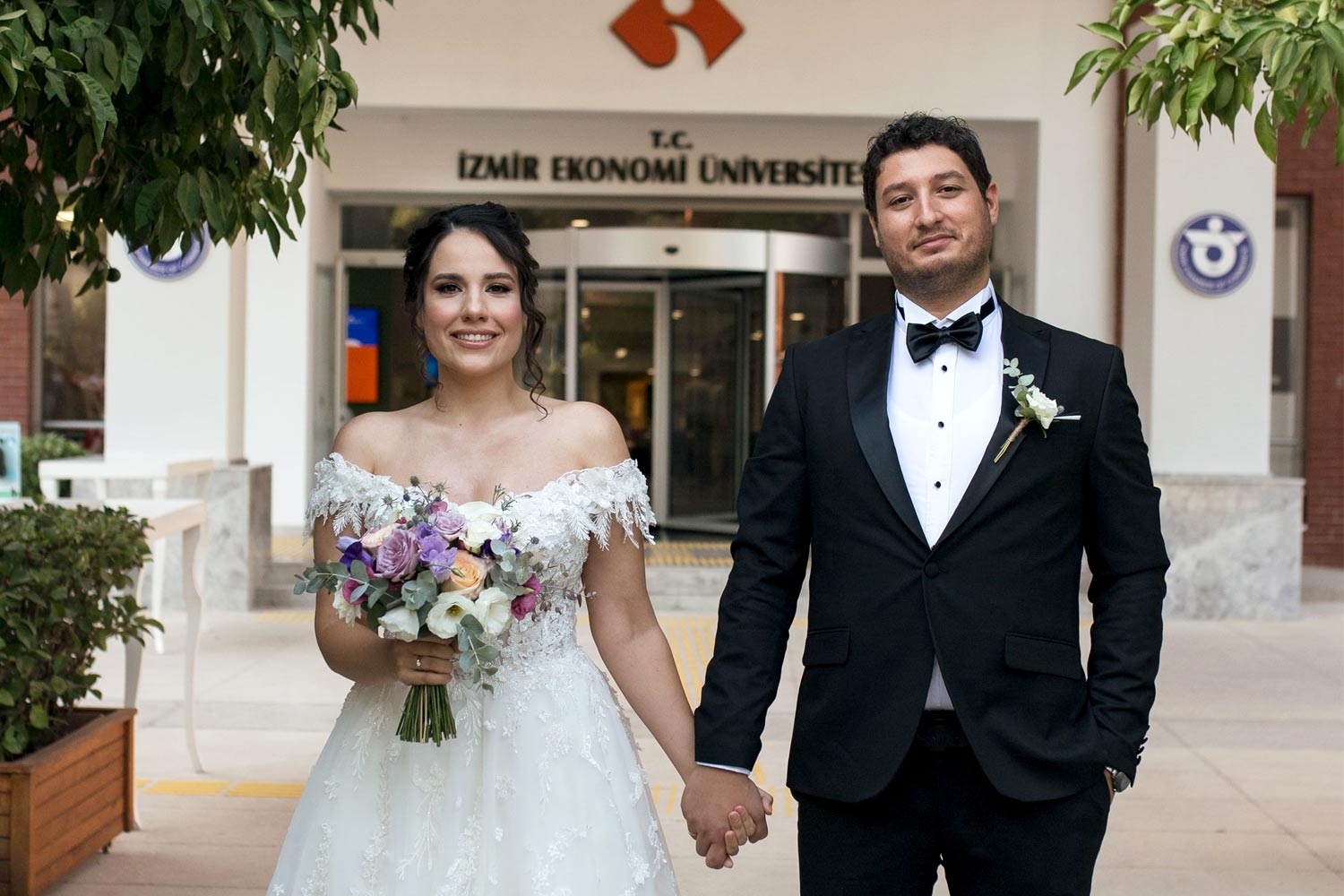 A bride and a groom on campus